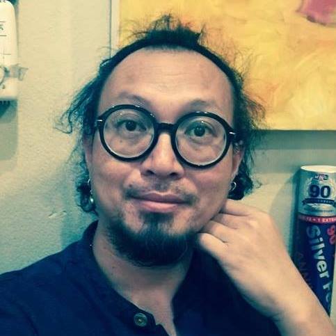 a man in round glasses, kind of looks like ganesha